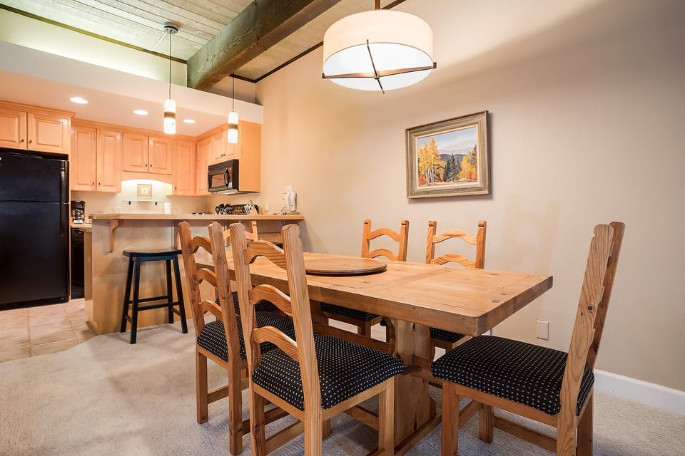 Gather around this warm wooden dining table for memorable meals with your group in the heart of your mountain retreat.