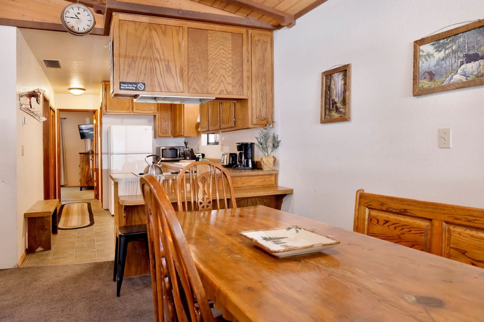 Fully equipped cabin kitchen with warm wood cabinets,stove, fridge, microwave, and coffee maker—perfect for cooking meals, morning coffee, and feeling right at home on your Airbnb stay.