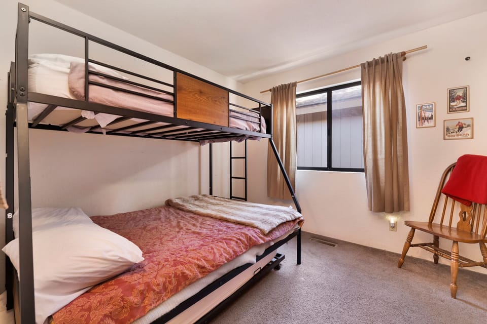 Peaceful cabin bedroom with plush bedding, and beautiful views—ideal for restful nights, cozy mornings, and a relaxing mountain escape.