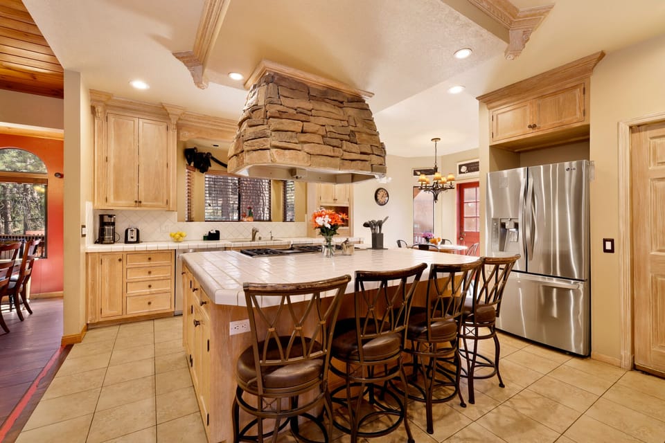 Fully equipped cabin kitchen with ample cabinetry, stove, fridge, microwave, and coffee maker—perfect for cooking meals, morning coffee, and feeling right at home on your stay.