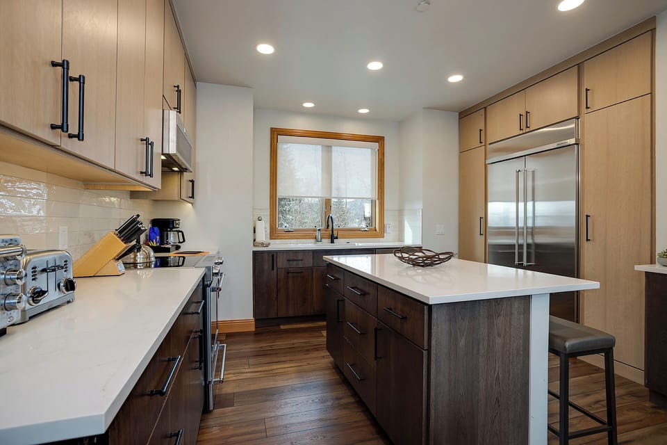 Your gourmet kitchen features sleek cabinetry, premium appliances, and a bright island where you can cook memorable meals with natural light streaming in.