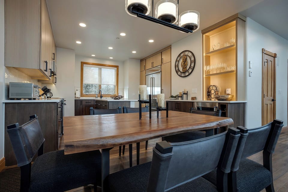 Your modern kitchen and dining area blend sleek design with warm wood accents, creating the perfect space for memorable meals.