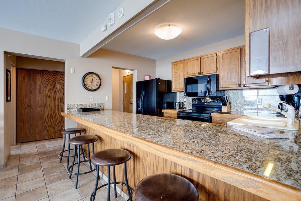 Your fully equipped kitchen invites memorable meals with granite countertops, bar seating, and everything you need to create culinary magic.