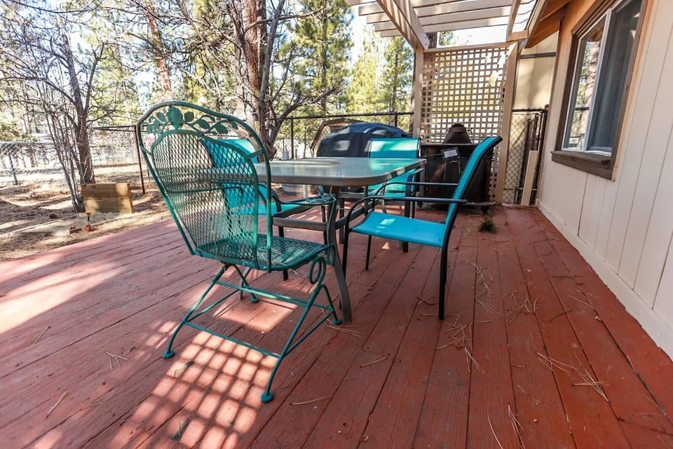 Unwind under the pines on the relaxing back patio area, complete with outdoor furnishings and a propane BBQ.