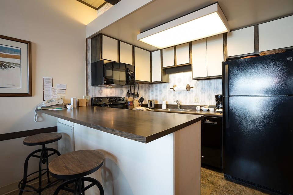 Your fully equipped kitchen awaits with modern appliances, granite countertops, and a breakfast bar perfect for morning coffee or evening meals.