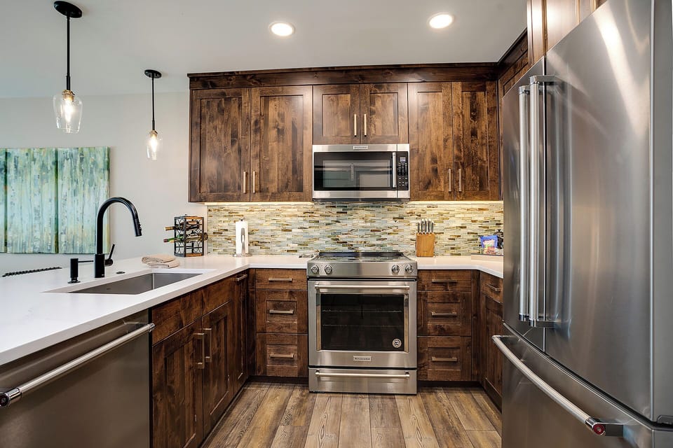Your gourmet kitchen awaits with rich wood cabinets, stainless steel appliances, and elegant pendant lighting for memorable meals.
