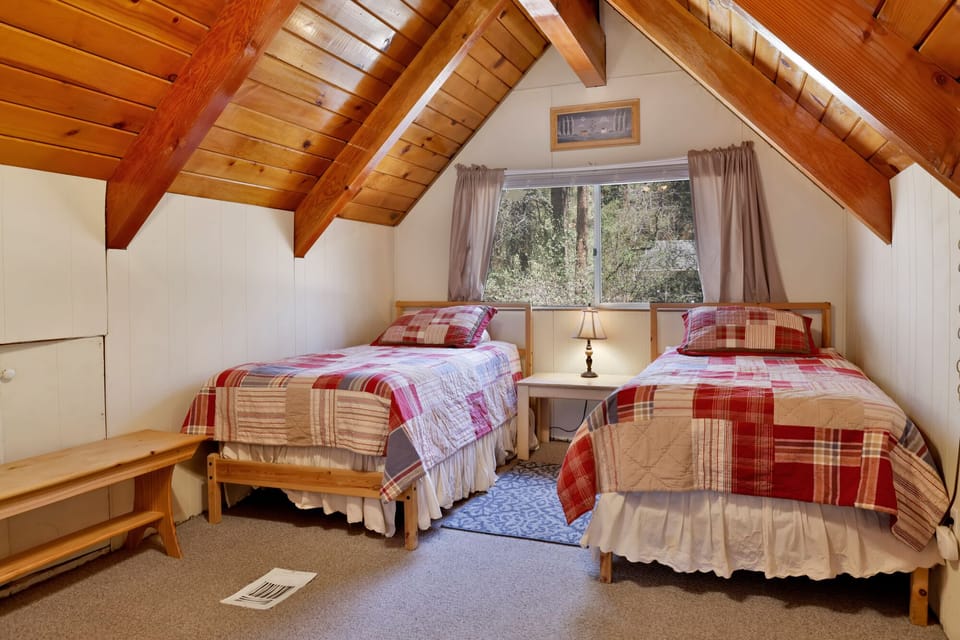 Upstairs loft with two twin beds, offering a cozy retreat perfect for kids or friends
