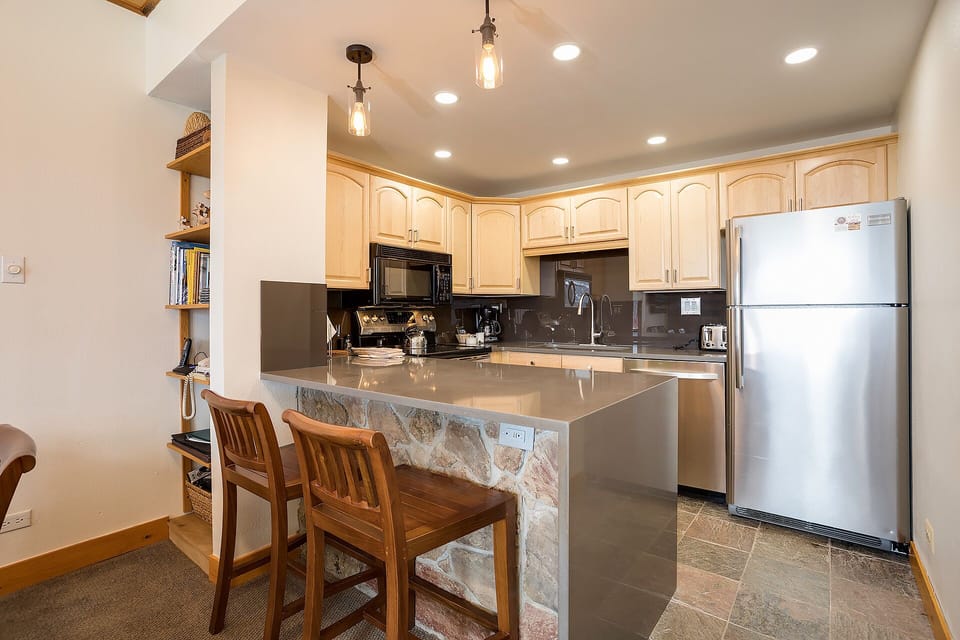 Cook memorable meals in your fully-equipped kitchen with granite counters, breakfast bar seating, and modern appliances ready for your culinary adventures.