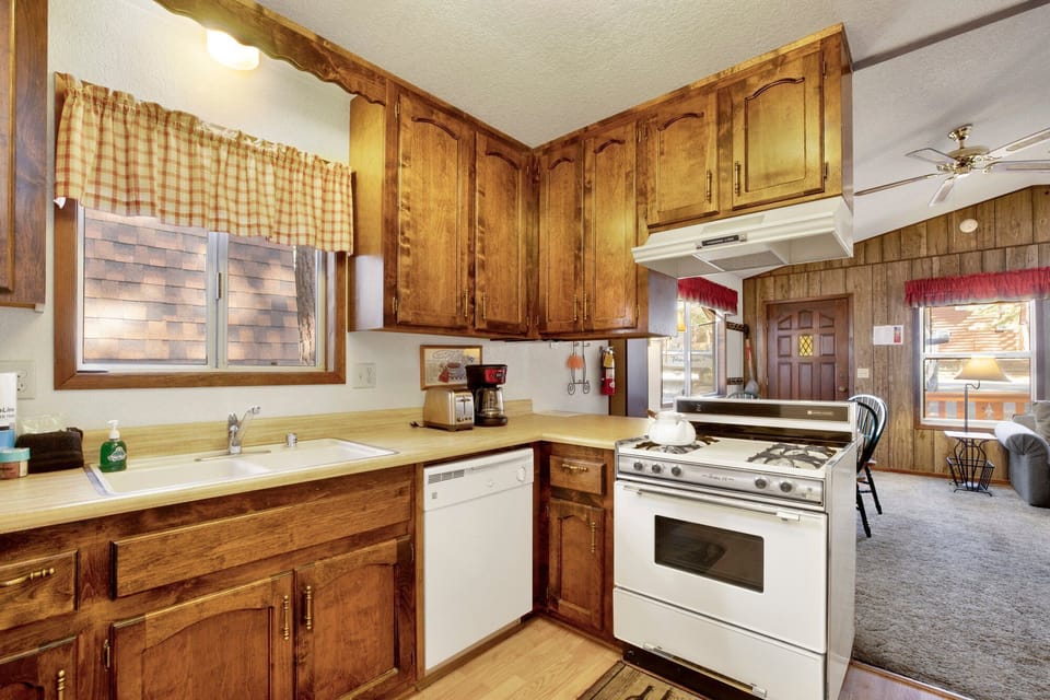 Prepare your favorite meals in this well-appointed kitchen. It comes fully equipped with a gas range, dishwasher, and ample cabinet space, ensuring you have everything needed for a stress-free stay.