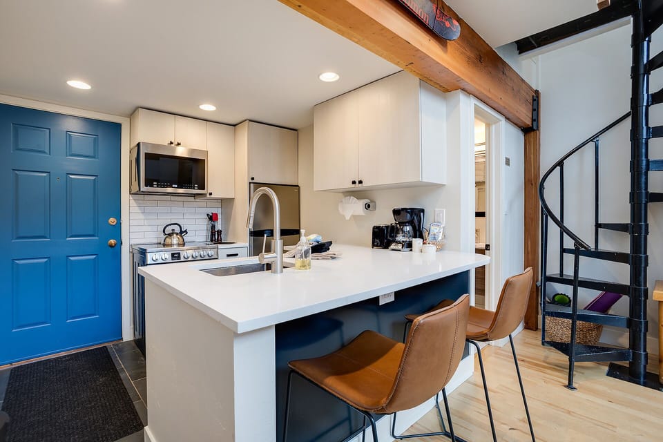 Your modern kitchen features sleek countertops, stainless appliances, and a cozy breakfast bar where you can enjoy morning coffee.