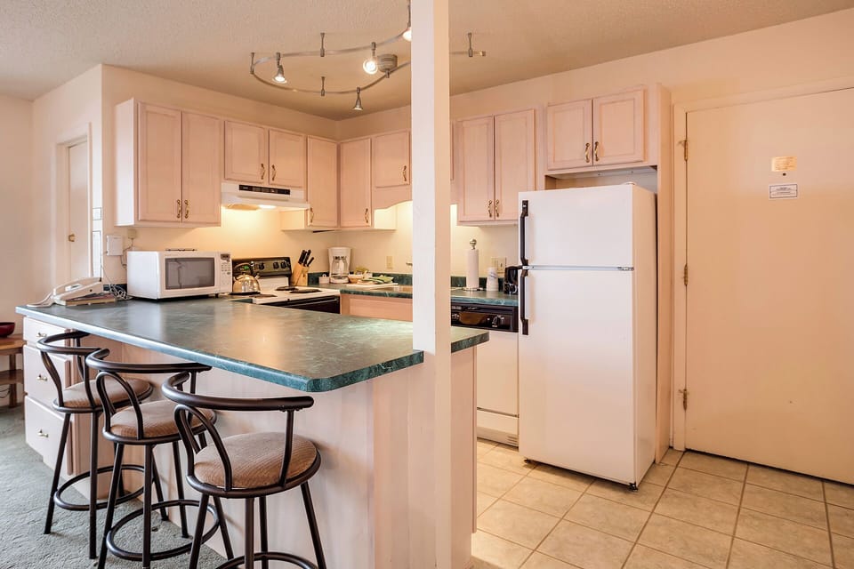 Your fully equipped kitchen features granite countertops, breakfast bar seating, and everything needed for home-cooked meals during your stay.
