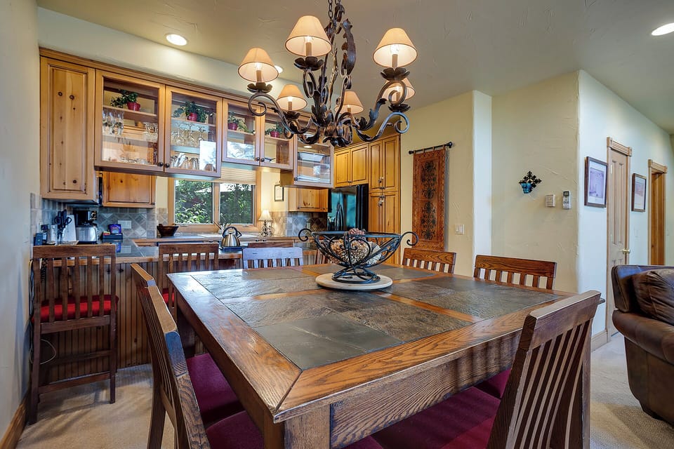 Gather around this stunning dining table where memories are made over shared meals, with your fully-equipped kitchen just steps away for culinary adventures.