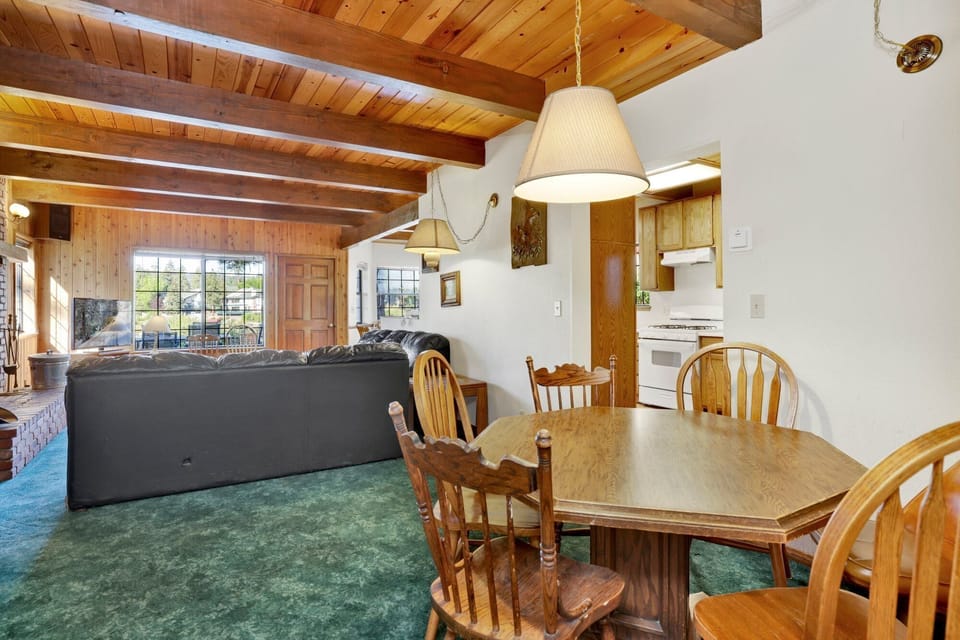 Fully equipped cabin kitchen with warm wood cabinets,stove, fridge, microwave, and coffee maker—perfect for cooking meals, morning coffee, and feeling right at home on your stay.