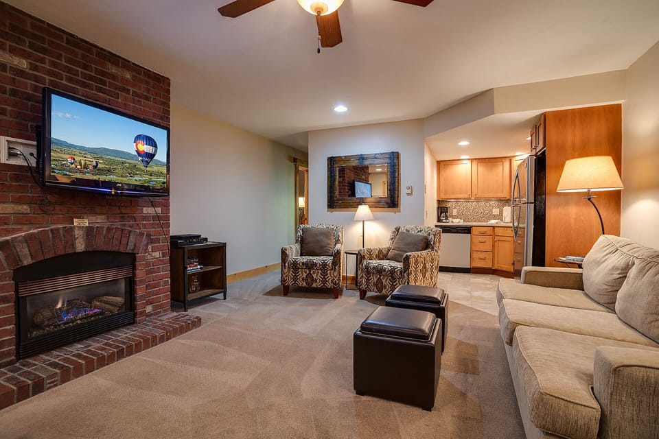 Sink into plush seating while the fireplace crackles and your favorite shows play on the large TV in this inviting living space.