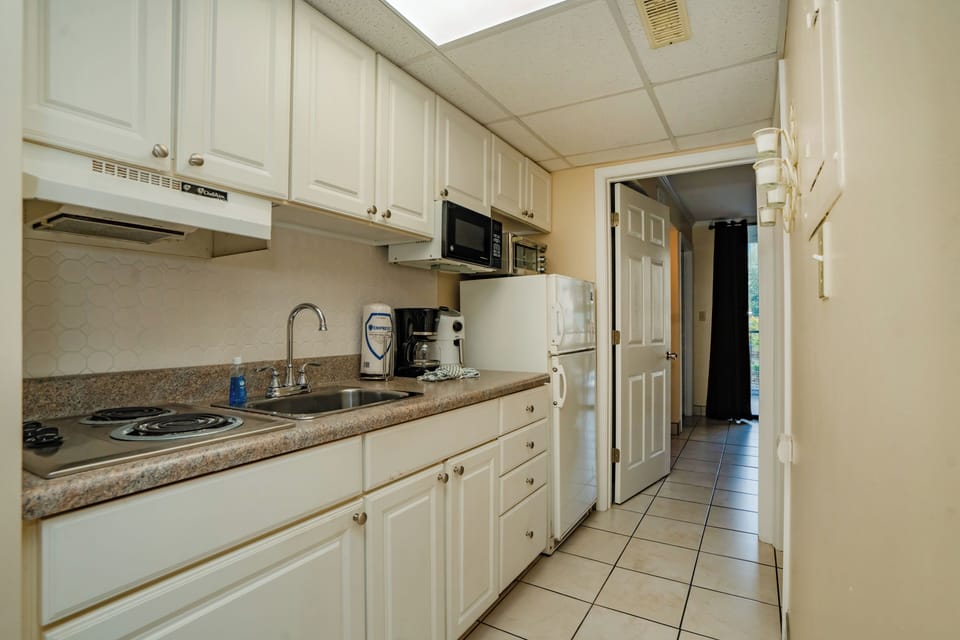 Your fully equipped kitchen features everything you need to prepare meals, from the stove and microwave to ample counter space and a coffee maker ready for your morning brew.