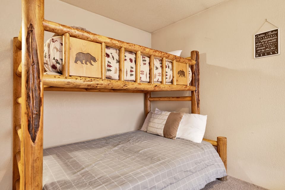 Peaceful cabin bedroom with plush bedding, and beautiful views—ideal for restful nights, cozy mornings, and a relaxing mountain escape.