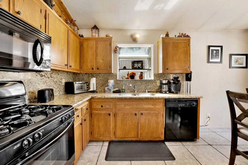 Fully equipped cabin kitchen with ample cabinetry, stove, fridge, microwave, and coffee maker—perfect for cooking meals, morning coffee, and feeling right at home on your stay.