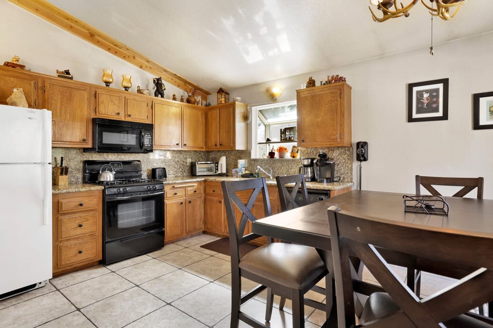 Fully equipped cabin kitchen with ample cabinetry, stove, fridge, microwave, and coffee maker—perfect for cooking meals, morning coffee, and feeling right at home on your stay.