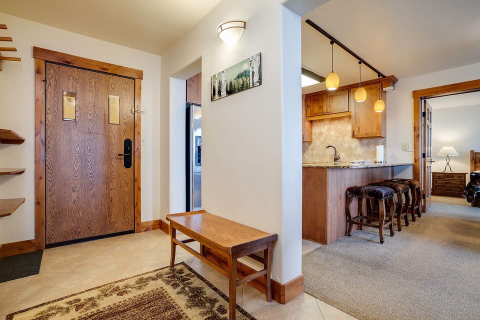 Step into your mountain retreat where warm wood tones and modern amenities create the perfect alpine getaway for your group.