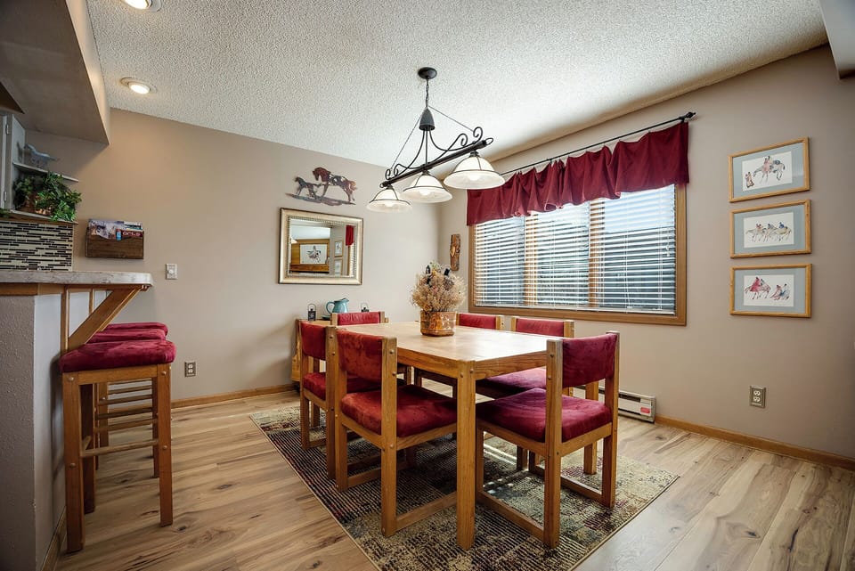 Gather around this warm dining space where rustic charm meets comfort - perfect for sharing meals and making memories together.