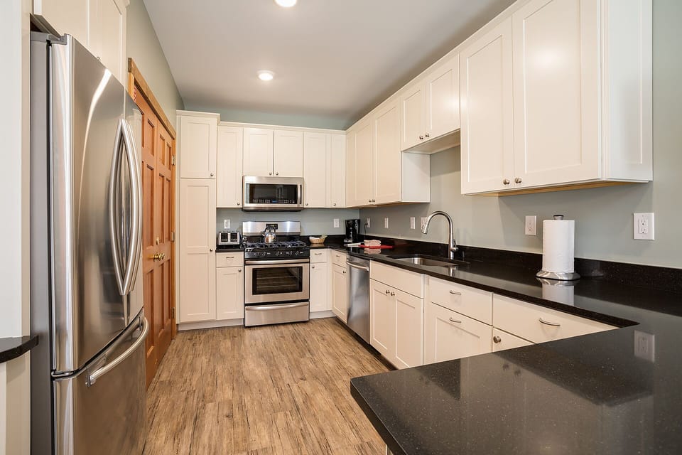 Your spacious, fully-equipped kitchen awaits with granite countertops, stainless steel appliances, and everything you need to create memorable meals.