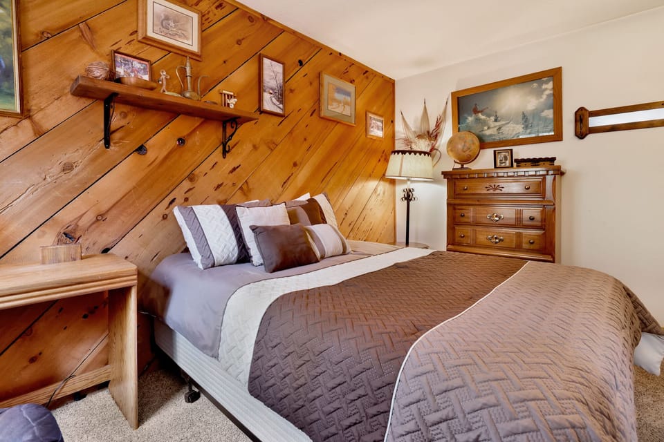 Peaceful cabin bedroom with plush bedding, and beautiful views—ideal for restful nights, cozy mornings, and a relaxing mountain escape.