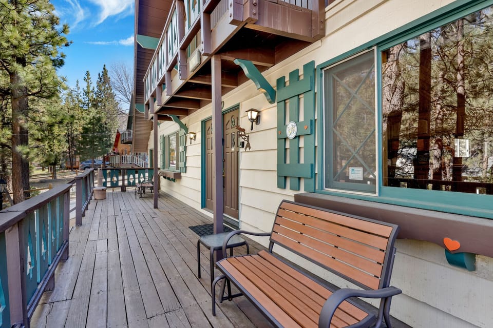 Welcoming cabin entry surrounded by towering pine trees, offering fresh mountain air and a peaceful forest setting—the perfect first impression for your Big Bear Lake getaway.