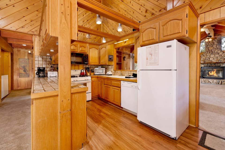 Fully equipped cabin kitchen with ample cabinetry, stove, fridge, microwave, and coffee maker—perfect for cooking meals, morning coffee, and feeling right at home on your stay.