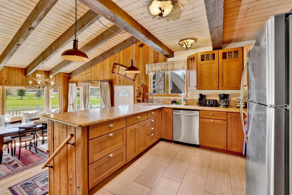 Fully equipped cabin kitchen with ample cabinetry, stove, fridge, microwave, and coffee maker—perfect for cooking meals, morning coffee, and feeling right at home on your stay.