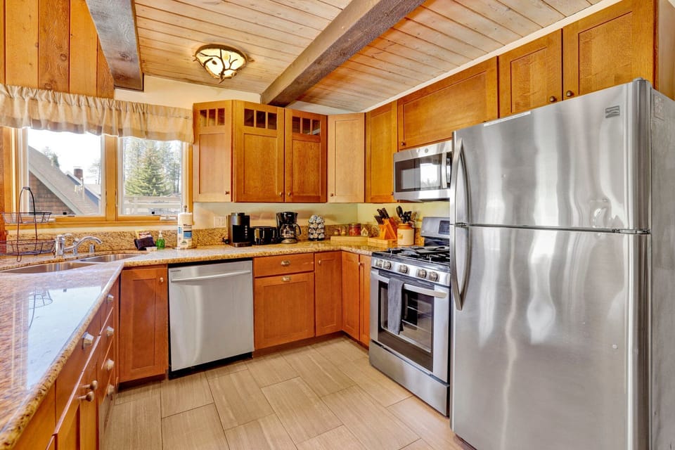 Fully equipped cabin kitchen with ample cabinetry, stove, fridge, microwave, and coffee maker—perfect for cooking meals, morning coffee, and feeling right at home on your stay.