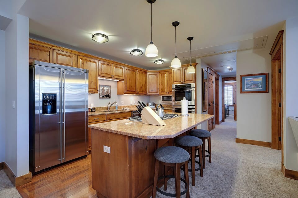Your fully equipped kitchen awaits with granite counters, stainless steel appliances, and a spacious island perfect for cooking memorable meals together.