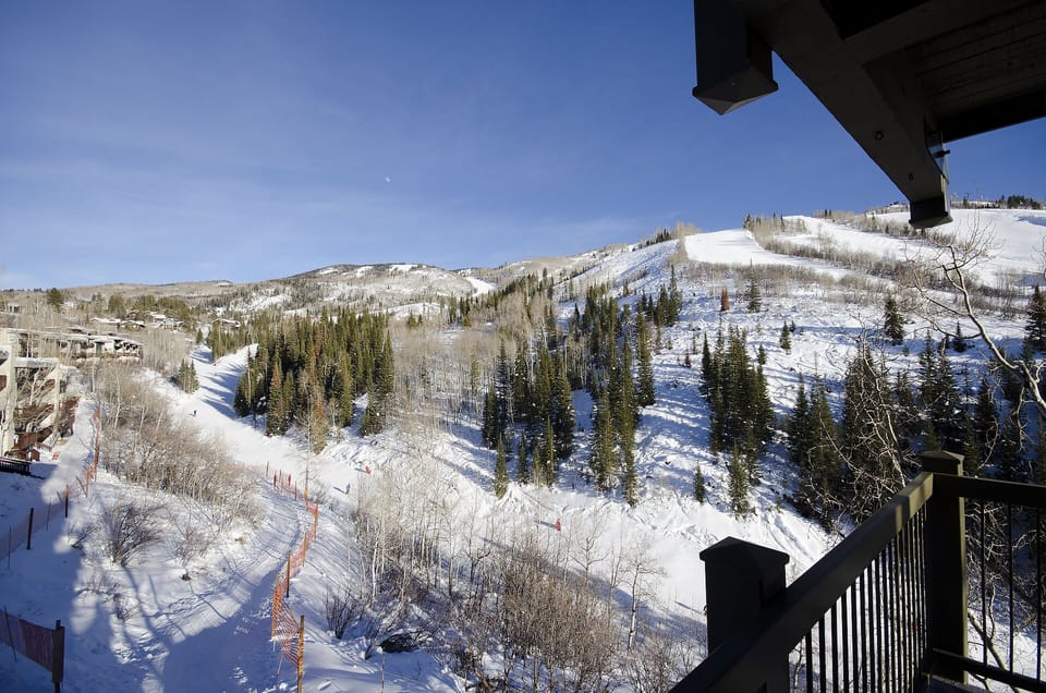Stunning ski slope views stretch across snow-covered mountains from your private balcony, creating a perfect winter mountain retreat.
