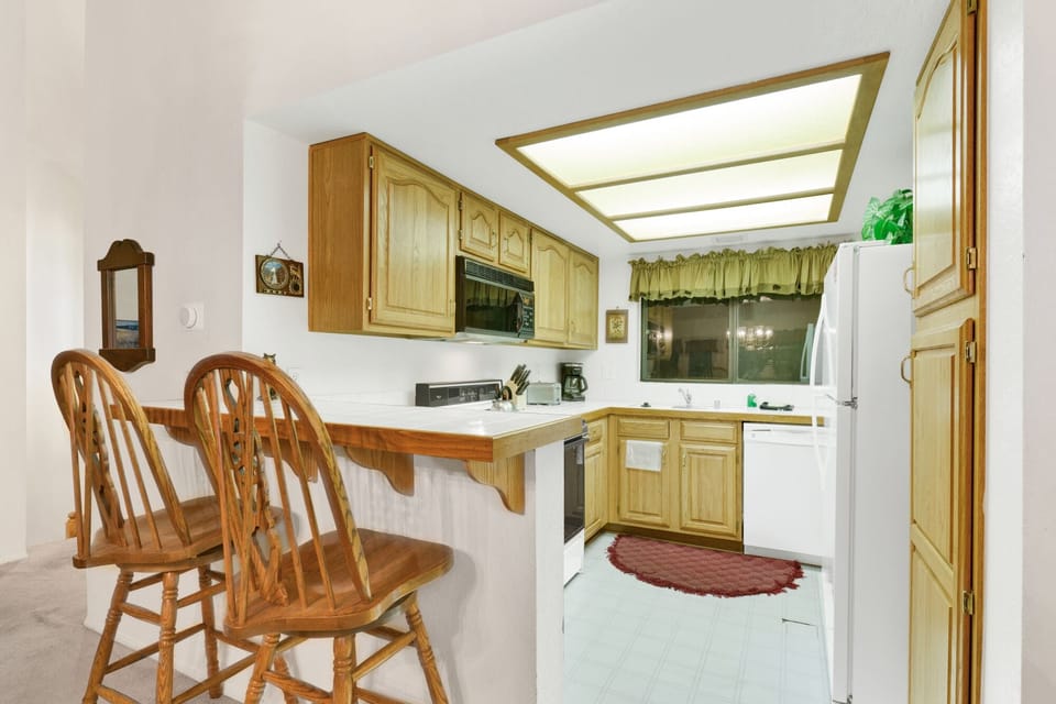 Fully equipped cabin kitchen with ample cabinetry, stove, fridge, microwave, and coffee maker—perfect for cooking meals, morning coffee, and feeling right at home on your stay.
