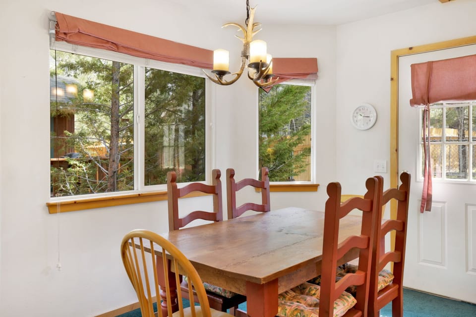 Kitchen with a refrigerator, stove, microwave, oven, toaster, coffee machine, blender, dishwasher, and a dining table to enjoy a delicious meal.
