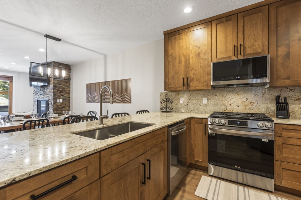 The well-equipped kitchen has beautiful wood cabinets and granite counters.