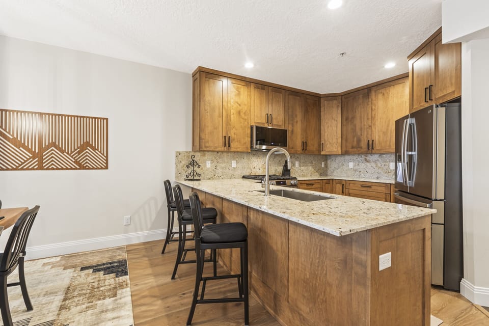 The well-equipped kitchen has beautiful wood cabinets and granite counters.