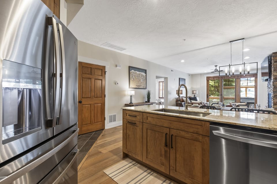 The well-equipped kitchen has beautiful wood cabinets and stainless steel appliances.
