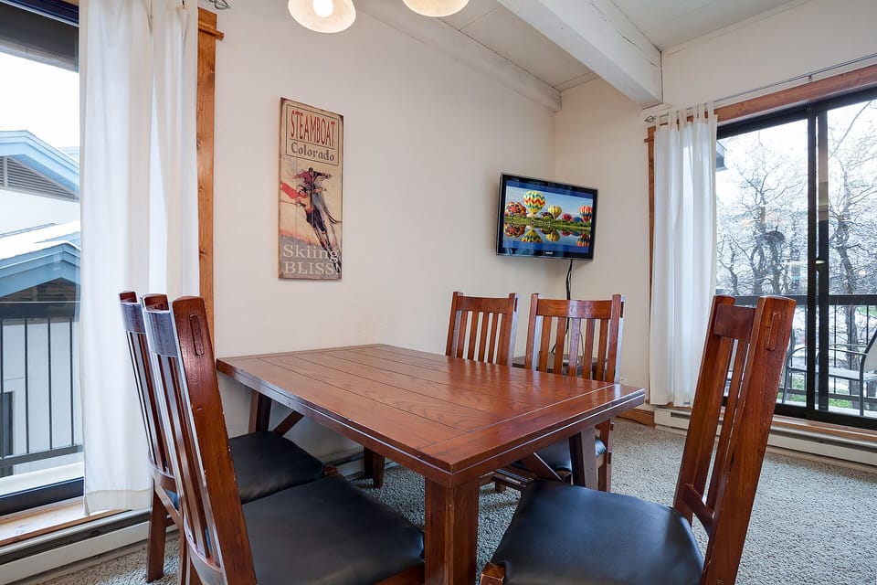 Gather around your spacious dining table for memorable meals with mountain views through floor-to-ceiling windows.