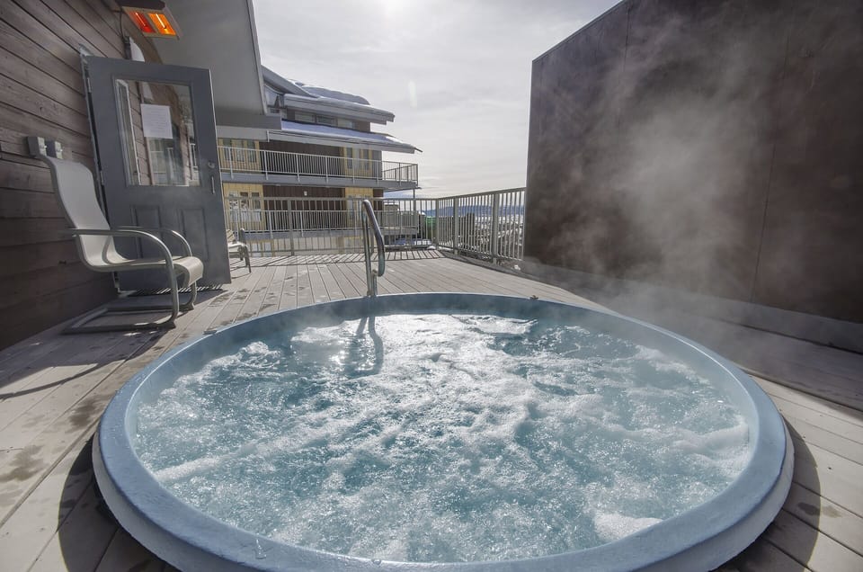 Soak away your worries in this bubbling hot tub on your private deck, surrounded by mountain views.