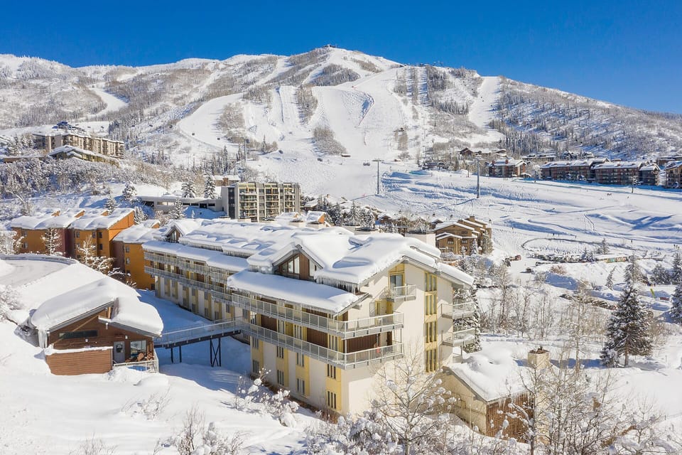 Stunning winter alpine resort nestled in snow-covered mountains with ski slopes and village buildings creating the perfect mountain getaway setting.