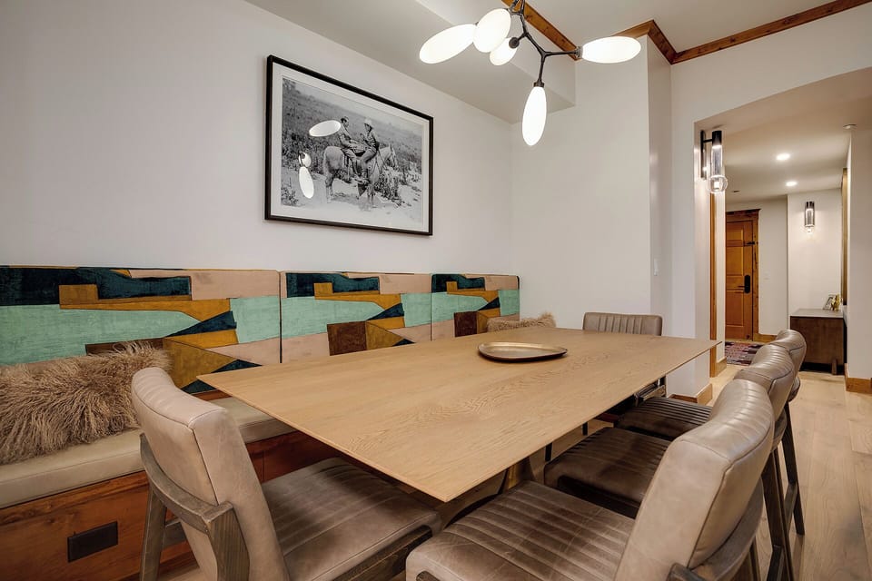 Gather around this spacious dining table for memorable meals with your travel companions in this thoughtfully designed space.