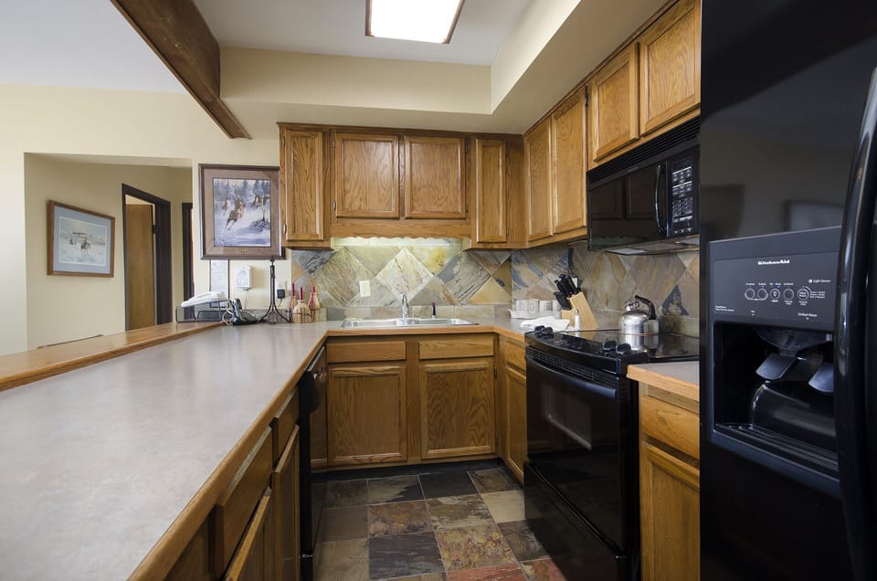 Your fully equipped kitchen features warm wood cabinets, modern appliances, and plenty of counter space for preparing memorable meals during your stay.