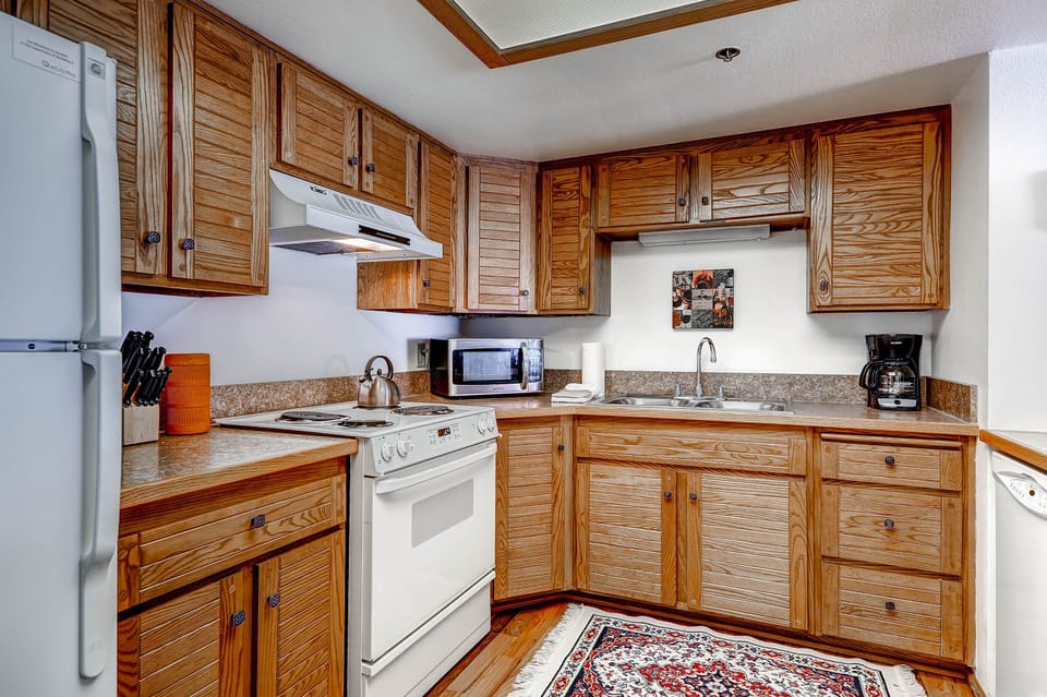 Park Station 218 has a well-equipped kitchen with wood cabinets.