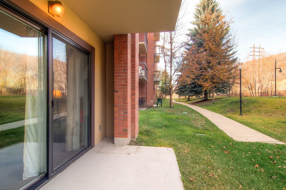 The private patio overlooks a lovely walking trail.