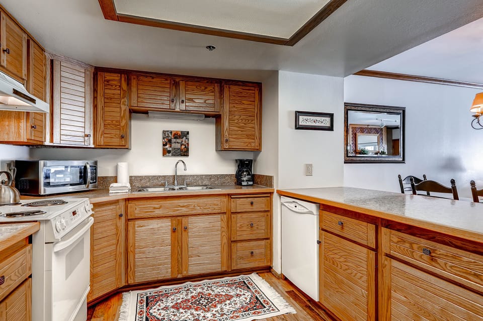 Park Station 218 has a well-equipped kitchen with wood cabinets.
