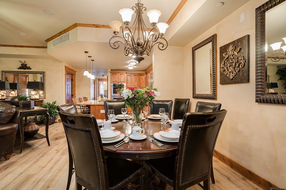 Gather around your elegant dining table for memorable meals beneath the ornate chandelier in this beautifully appointed space.