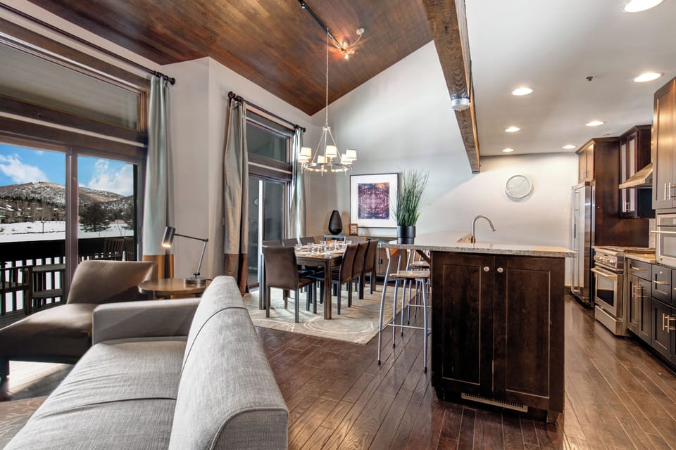 The open concept living room, dining and kitchen area with high ceilings.