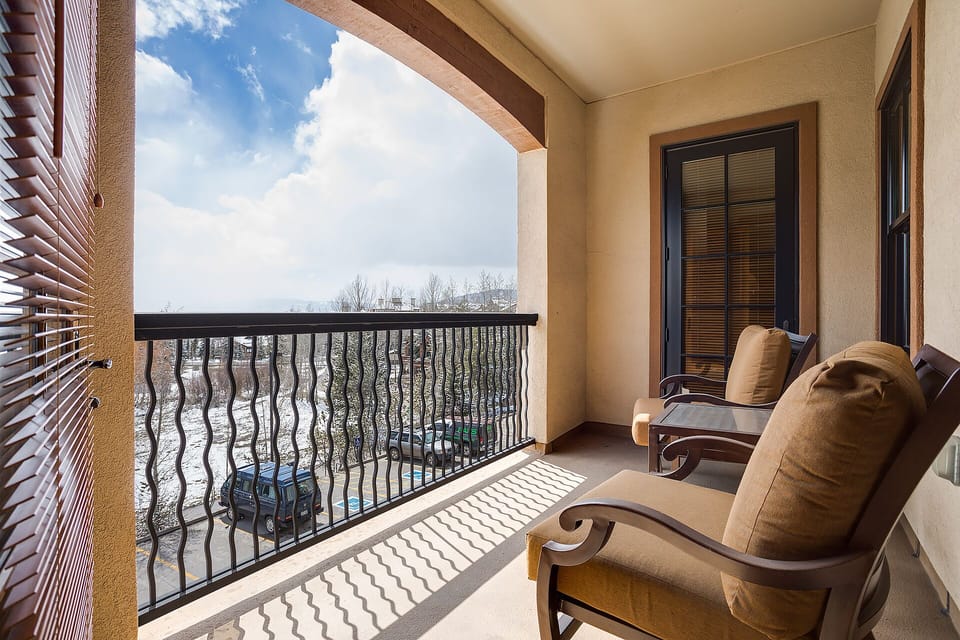 Your private balcony beckons with comfortable seating where you can unwind while taking in the peaceful views beyond.