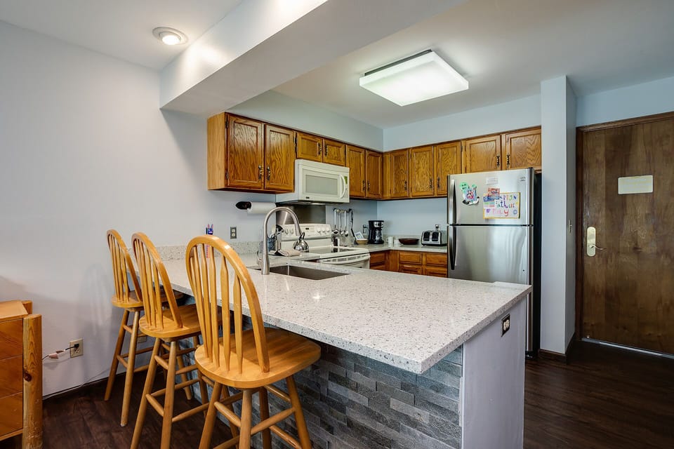 You'll love preparing meals in this fully equipped kitchen with granite counters, stainless appliances, and a breakfast bar for casual dining.