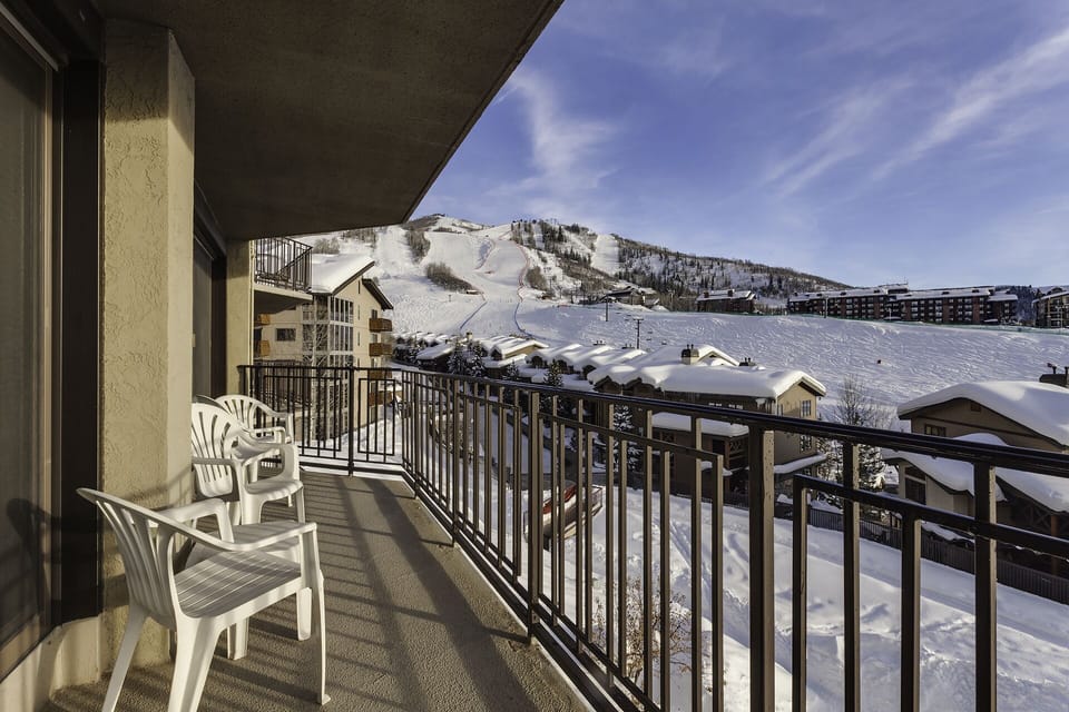 Step onto your private balcony and breathe in crisp mountain air while admiring stunning snow-covered peaks and ski slopes stretching before you.